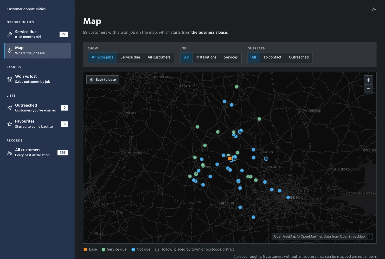The dashboard's map screen. 58 customers with a won job are plotted as dots across Oxfordshire, Buckinghamshire and the surrounding counties, around an orange square for the business's base. Green dots are due for a service and blue dots are not. Filters above the map switch between all won jobs, service due and all customers, between installations and services, and by outreach status. The business's name and address are removed.